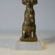 Brass sculpture, bear looking for honey in the tree