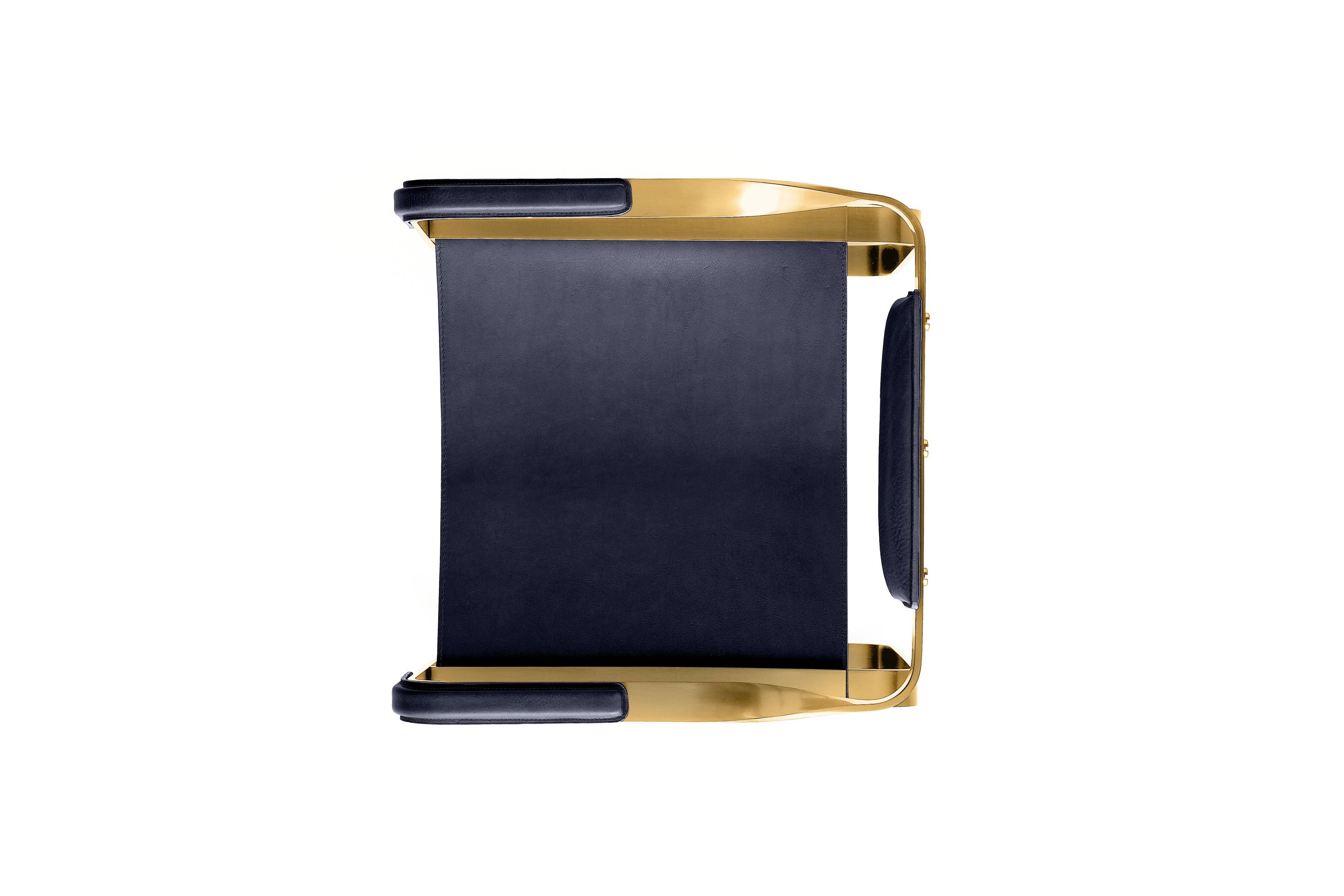 Armchair, aged brass and navy blue leather, contemporary style.