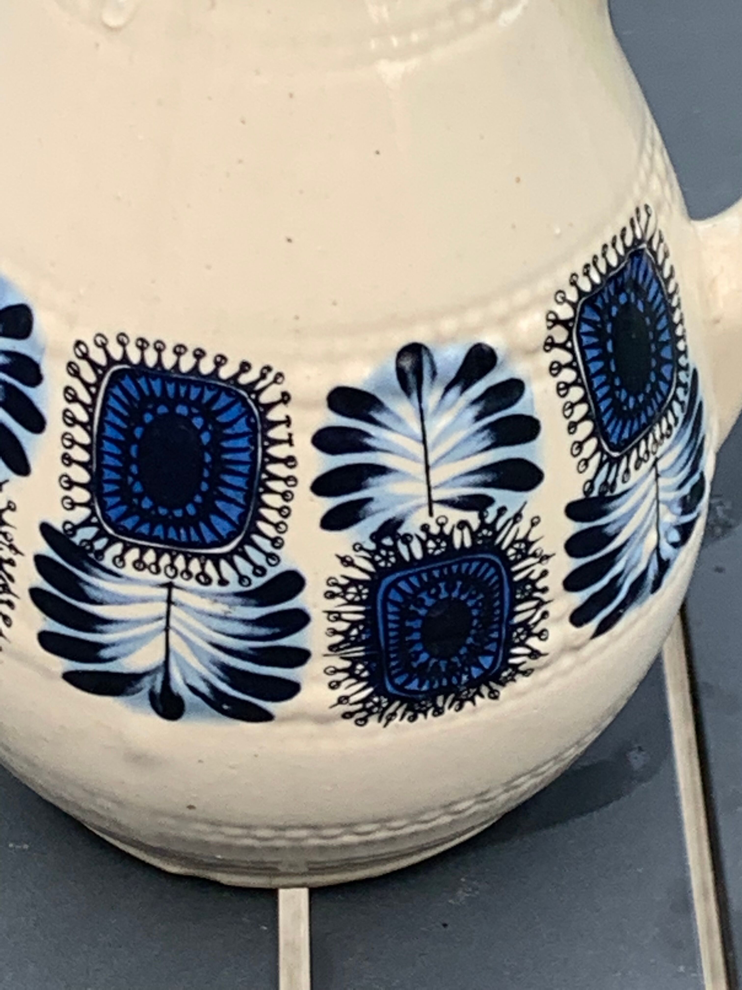 Enamelled sandstone carafe with a nice pattern of vintage blue flowers and 1970 design