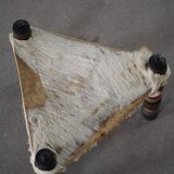 Vintage African artisanal stool, triangular shape with 3 legs, cowhide, 20th century.