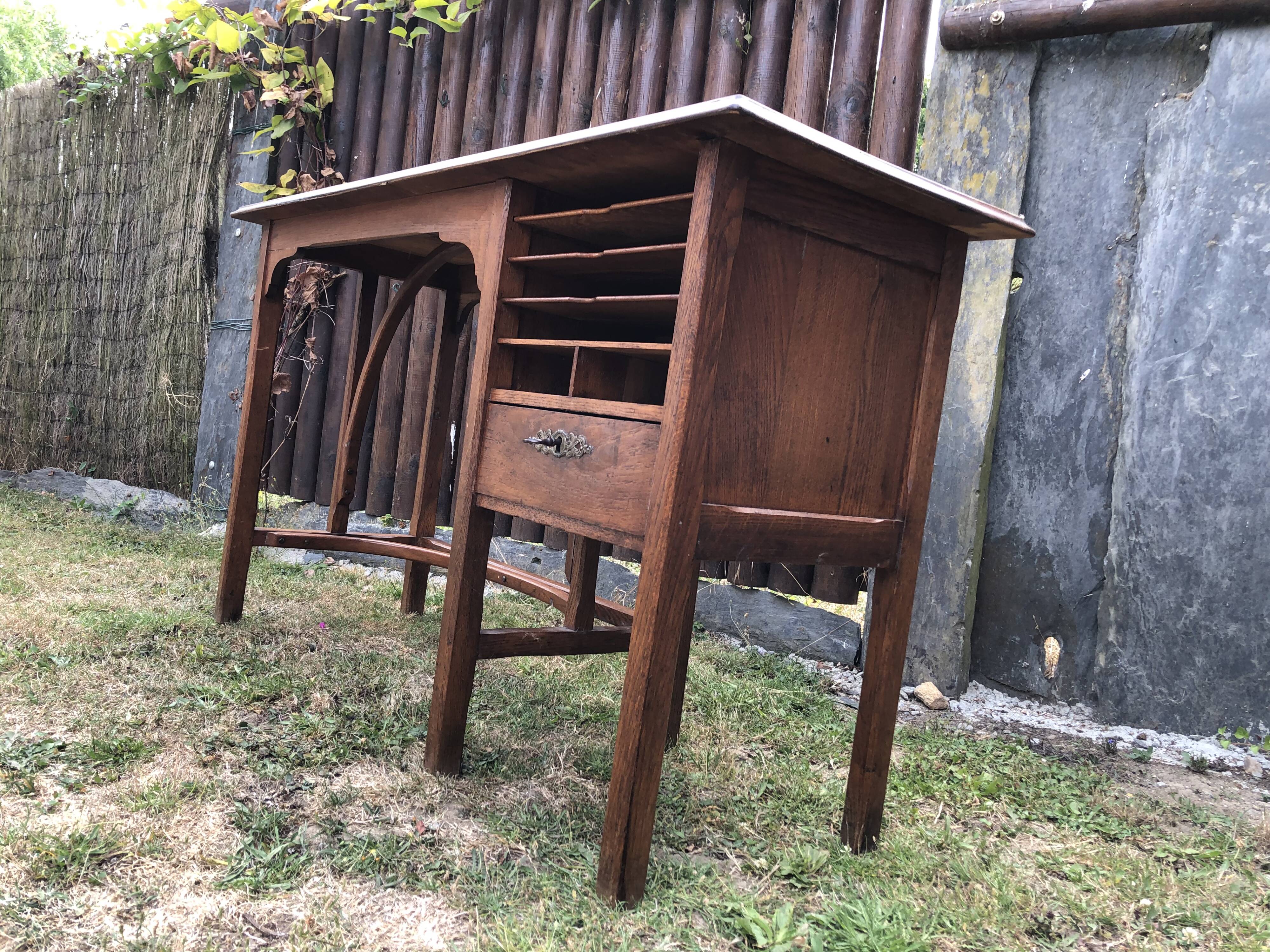 Old oak desk with curved wooden sleepers in the Art Nouveau spirit of the early 20th century.