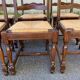 6 solid wood chairs in dark oak with a glossy finish and straw.