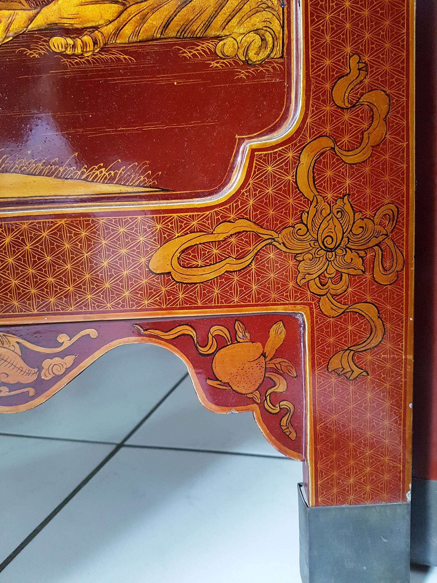 Four-panel Japanese-style screen in red and gold lacquer.