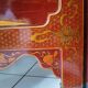 Four-panel Japanese-style screen in red and gold lacquer.