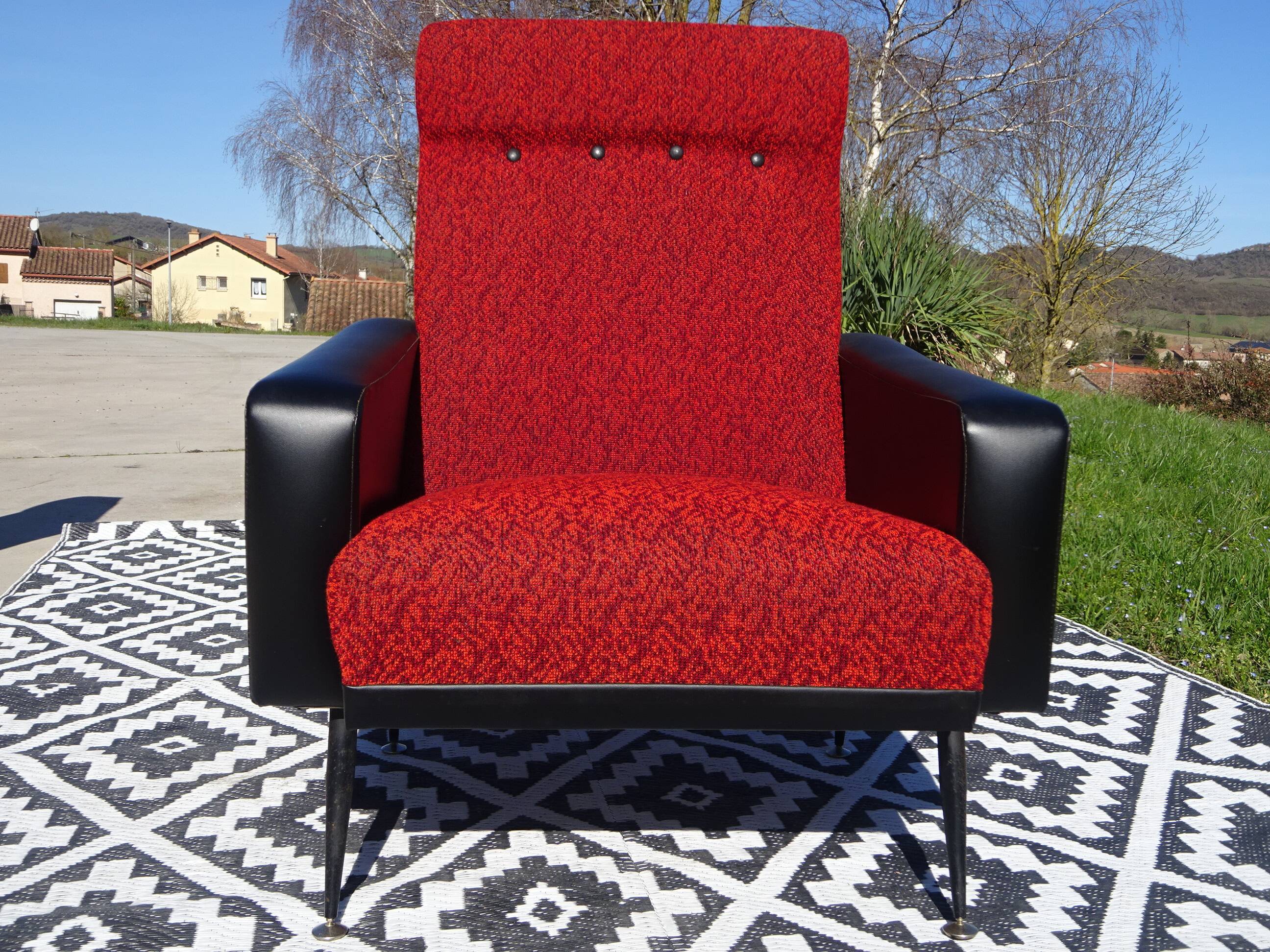 Vintage armchairs in red and black faux leather, the pair.