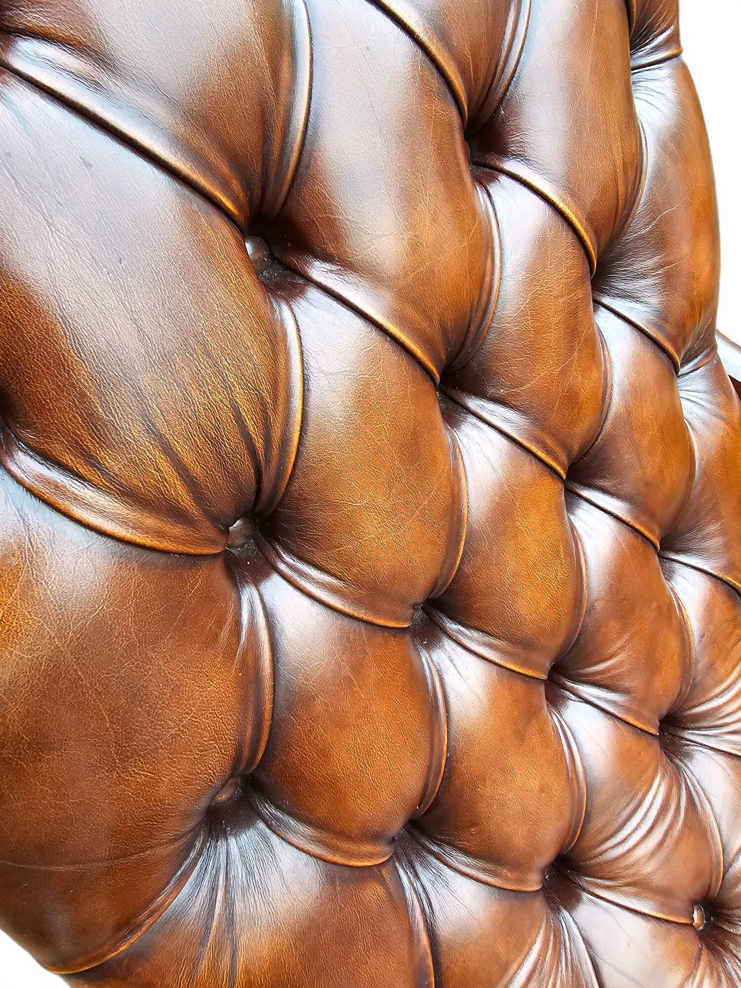 Pair of leather Chesterfields and footstools