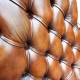 Pair of leather Chesterfields and footstools