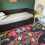 Bohemian floral design, handwoven wool rug, black background with colorful flowers
