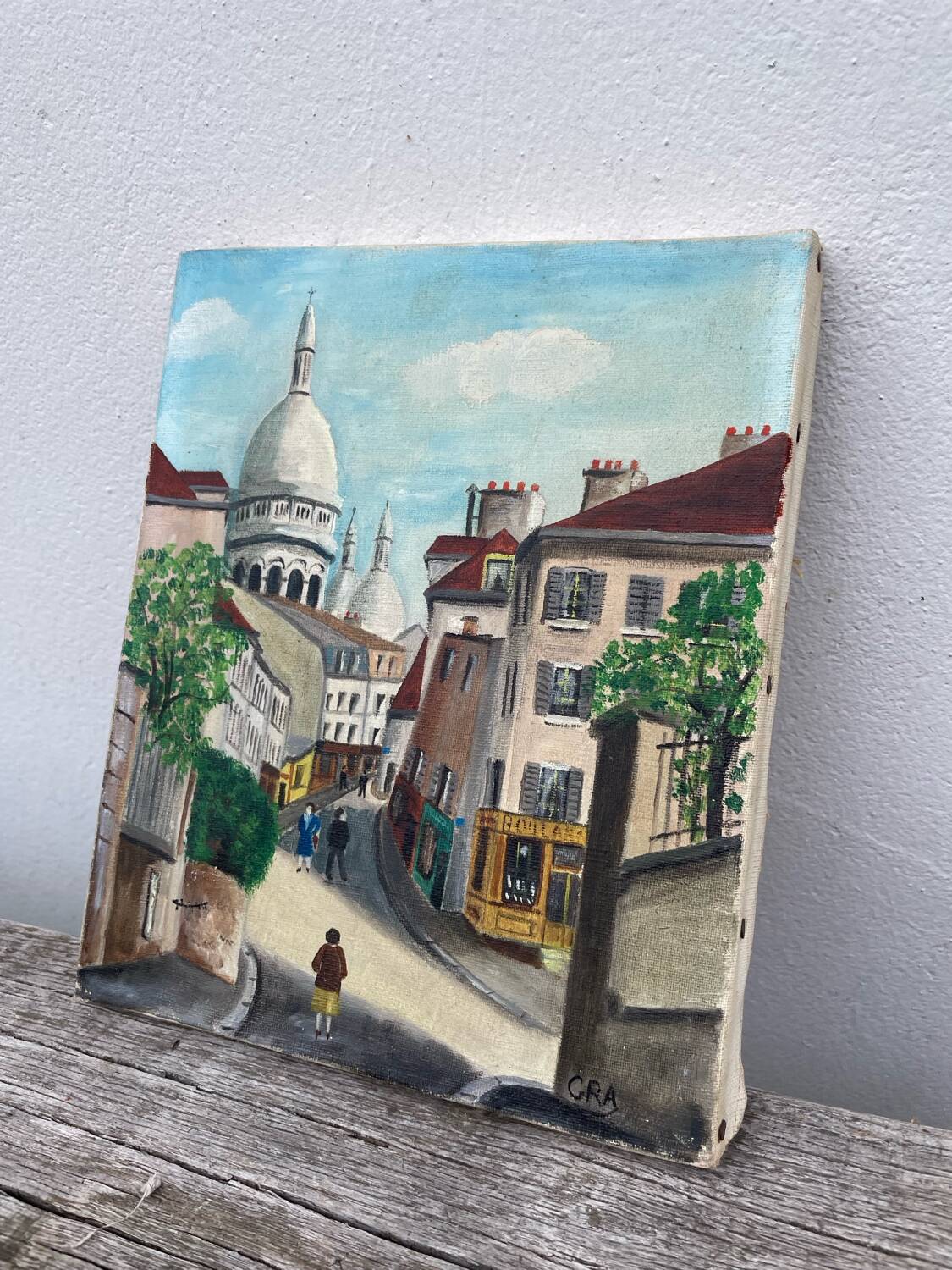 Old oil painting depicting a street in Montmartre