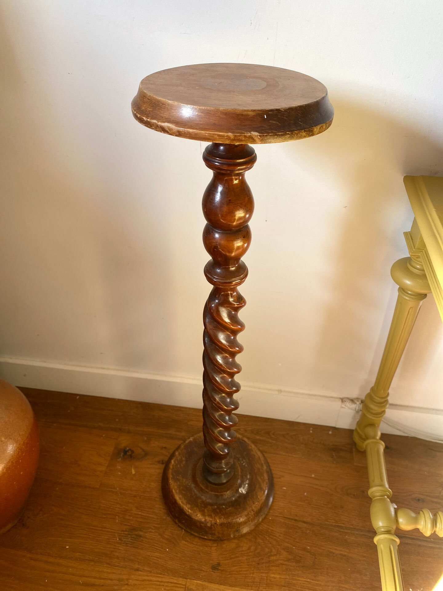 Antique pedestal table with a twisted column.