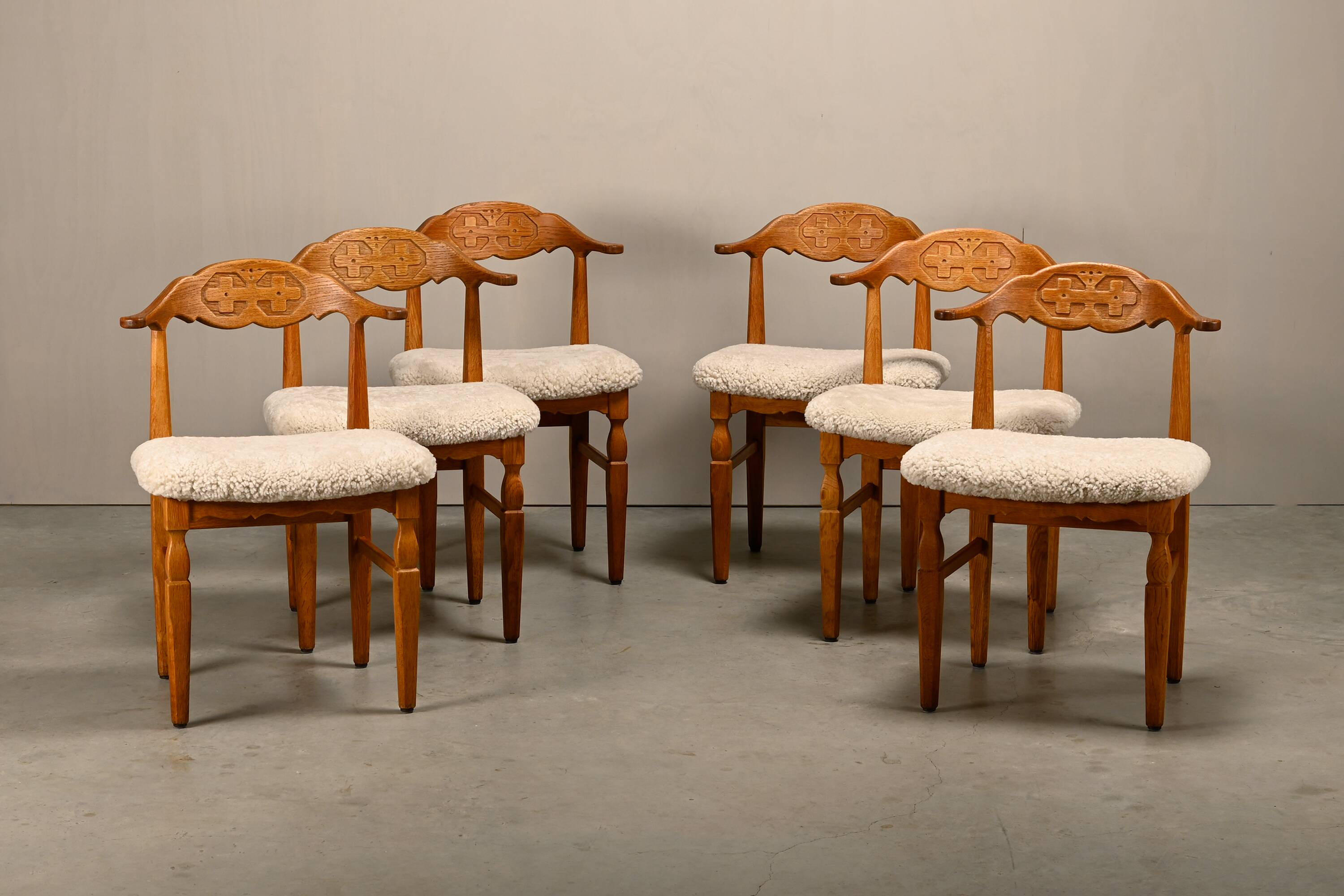 Henning Kjærnulf brutalist dining chairs set in Oak and Sheepskin, Denmark