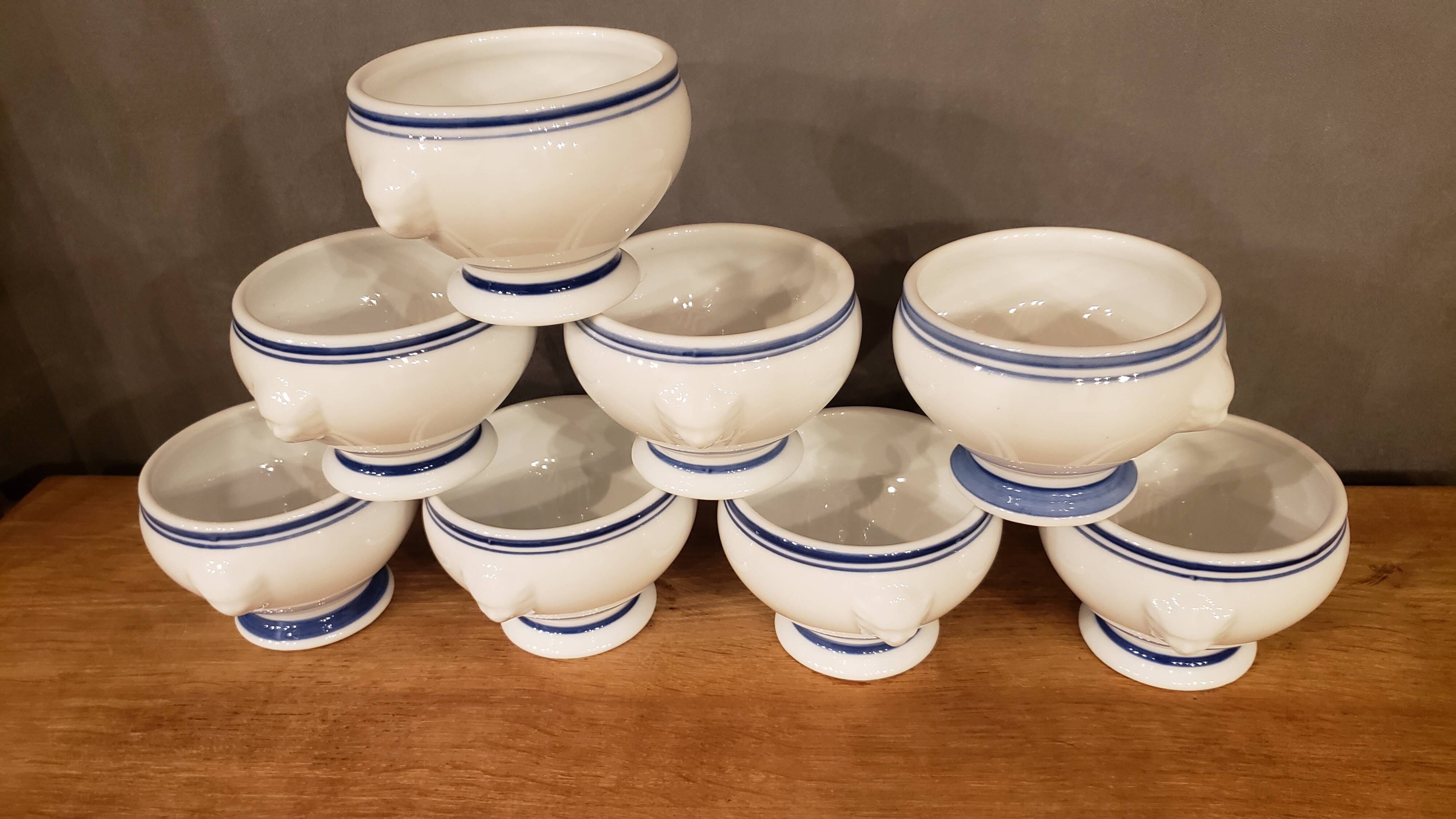 8 white lion head soup bowls with blue edging