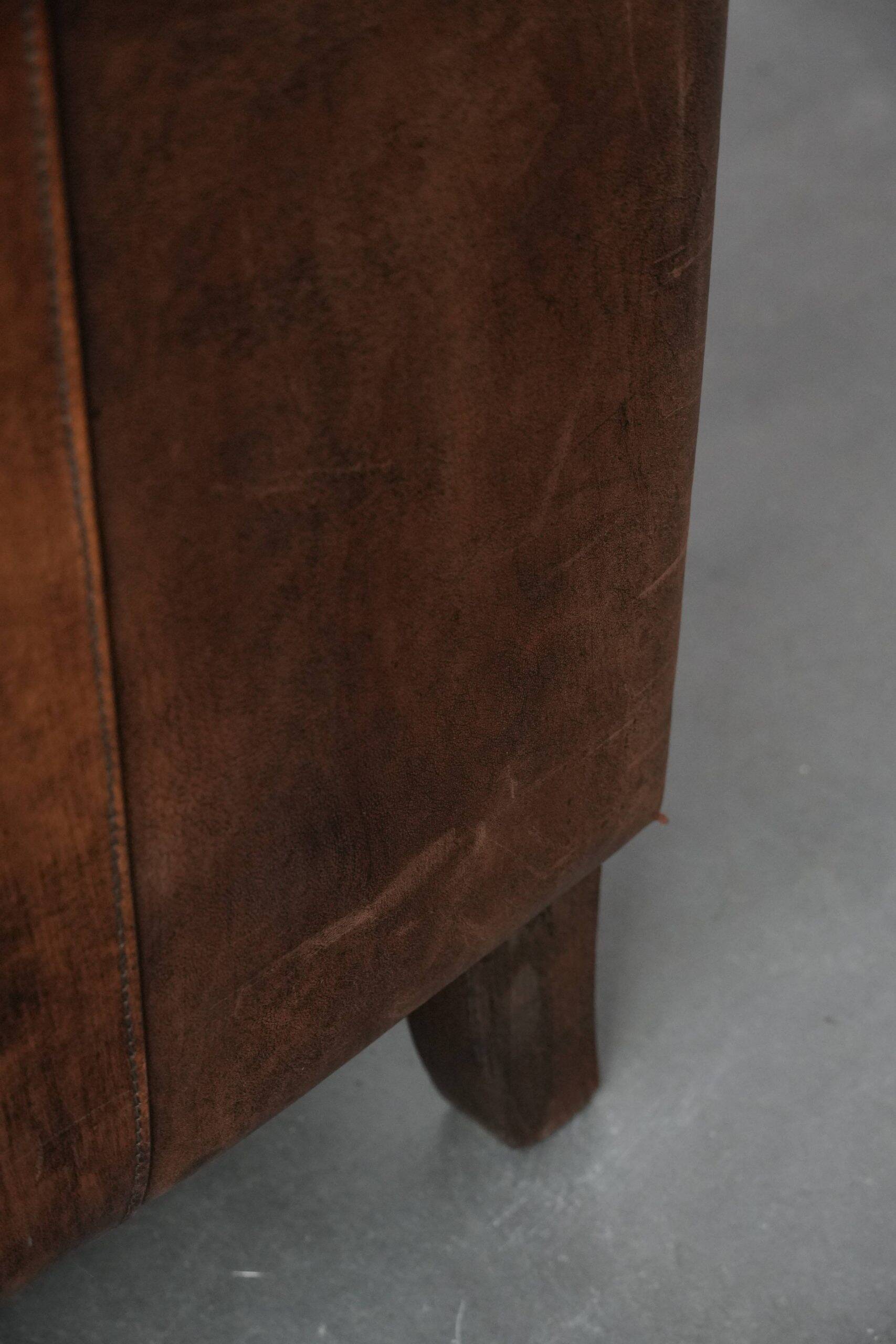 Set of 2 vintage sheepskin armchairs with a characterful appearance
