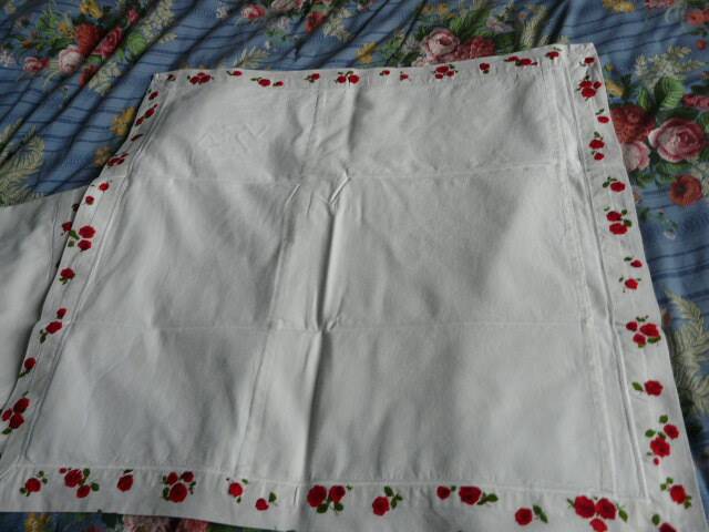 pair of monogrammed RB embroidered pillowcases in pink and red