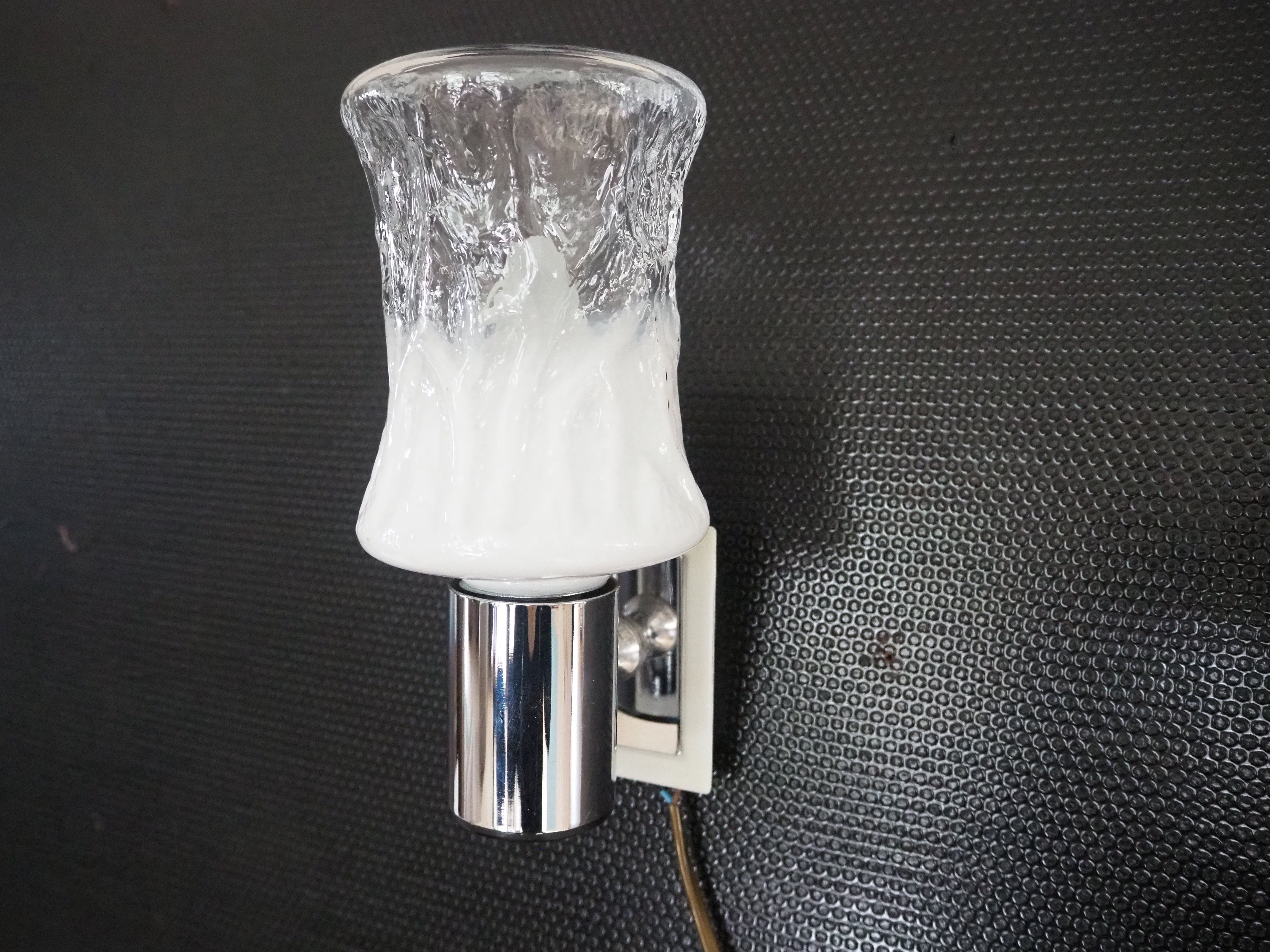 Torch type wall lamp in transparent and white glass
