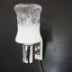 Transparent and white glass torch-type wall light.