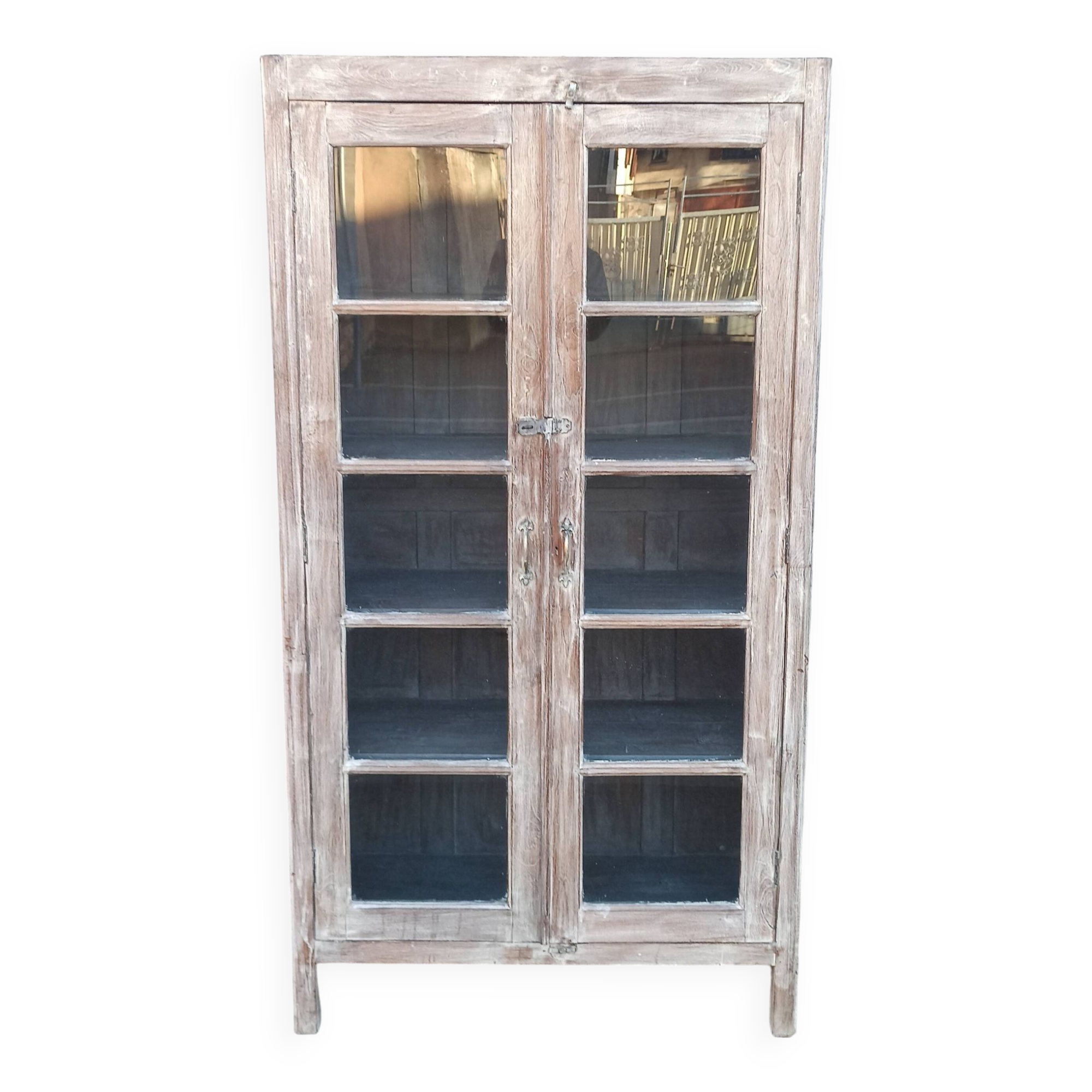 Glass cabinet in old whitewashed wood