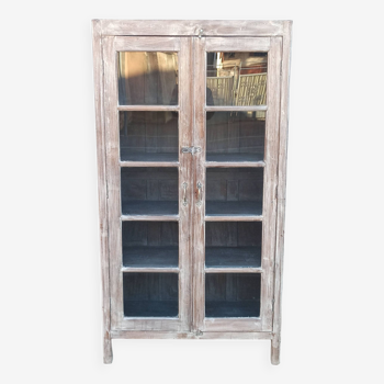 Glass cabinet in old whitewashed wood