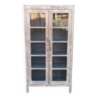 Glass cabinet in old whitewashed wood