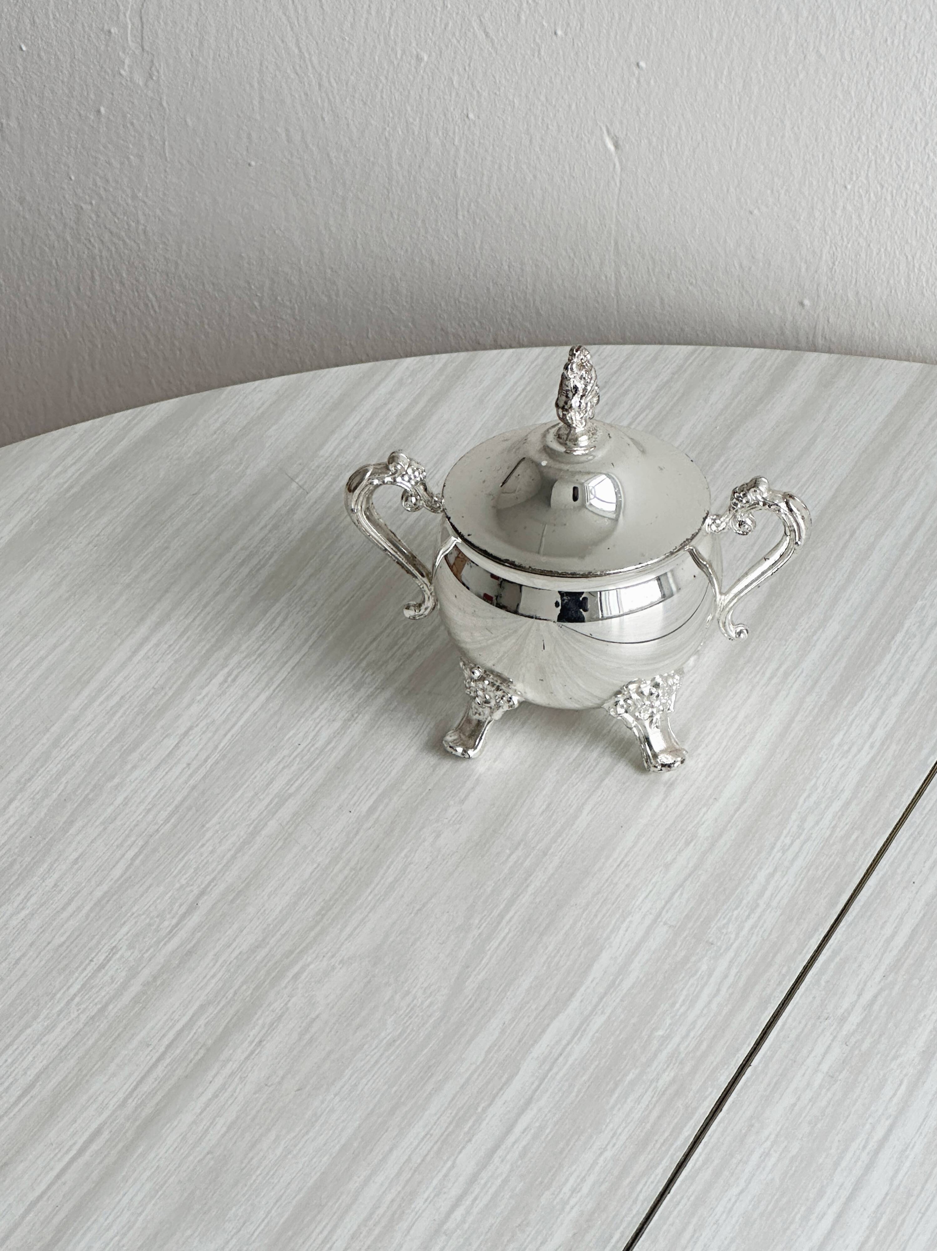 Antique shiny metal sugar bowl