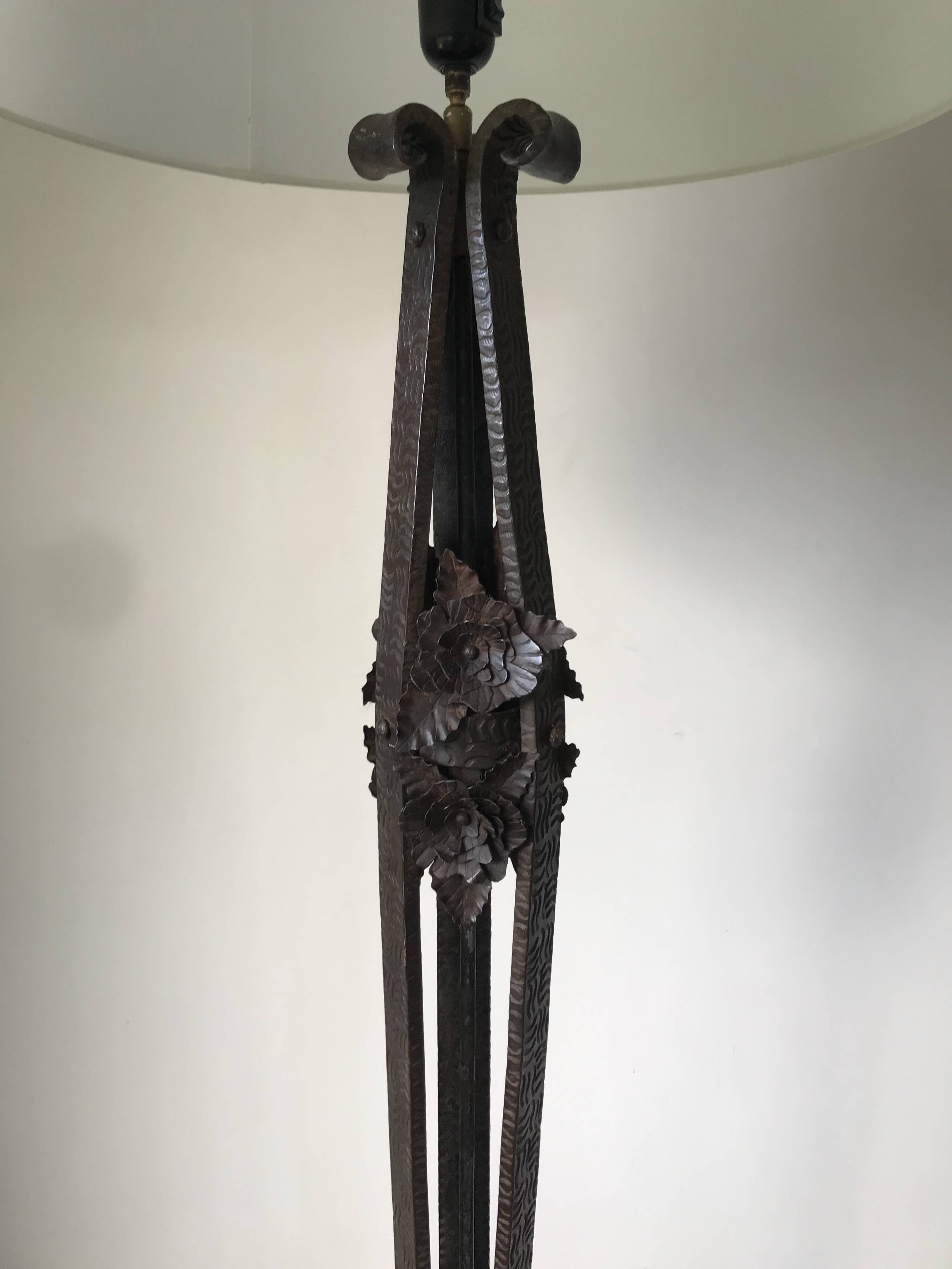 Art deco wrought iron floor lamp decorated with flowers, circa 1930.