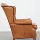 Fauteuil à oreilles en cuir de vache