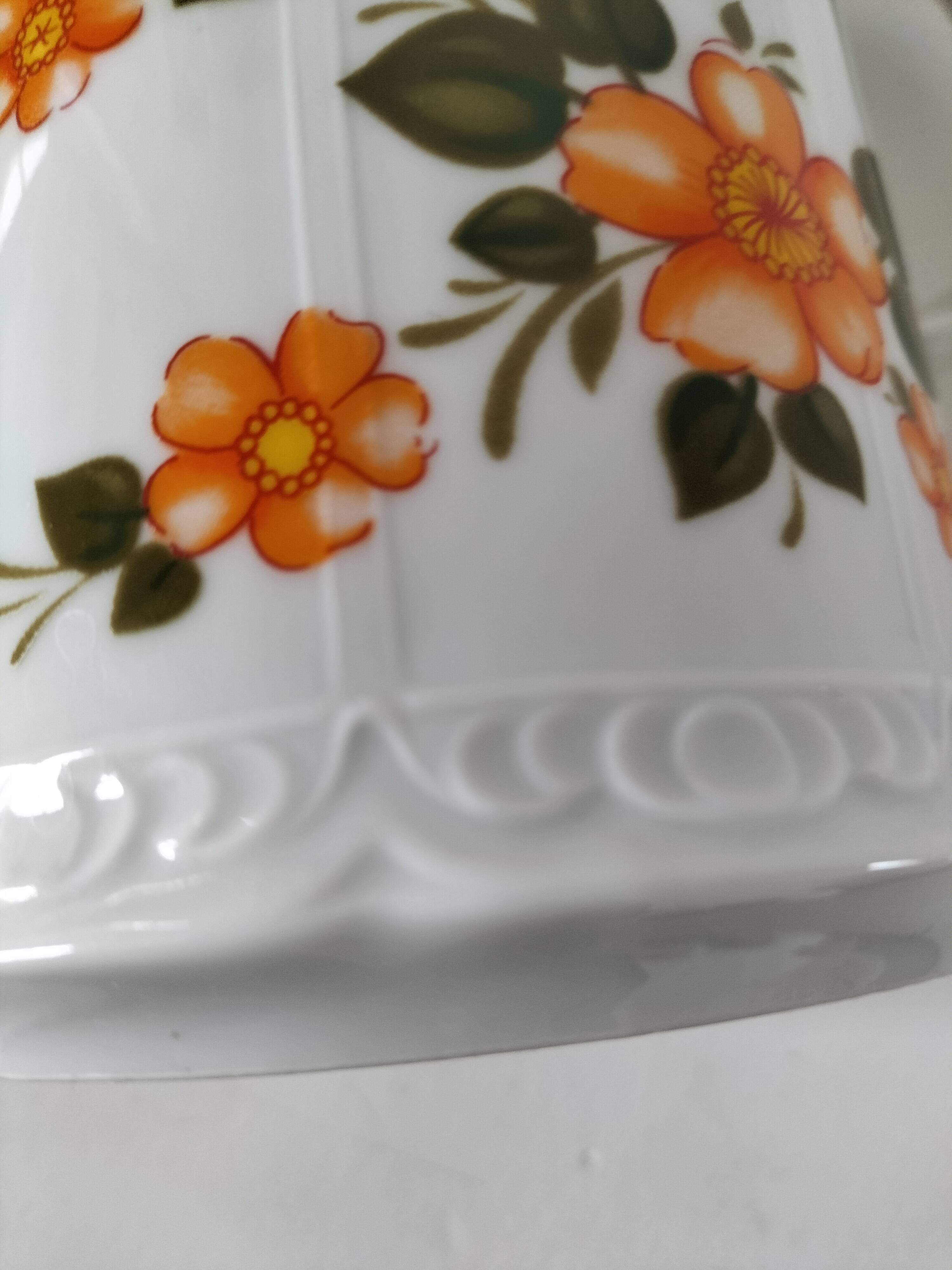 Vintage coffee pot Winterling Bavaria with orange floral decoration.