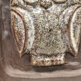 Small relief with a motif of an owl emerging from the back plate.