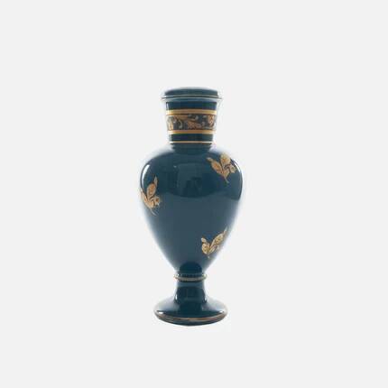 Small turquoise blue and gold porcelain vase with elegant floral patterns.