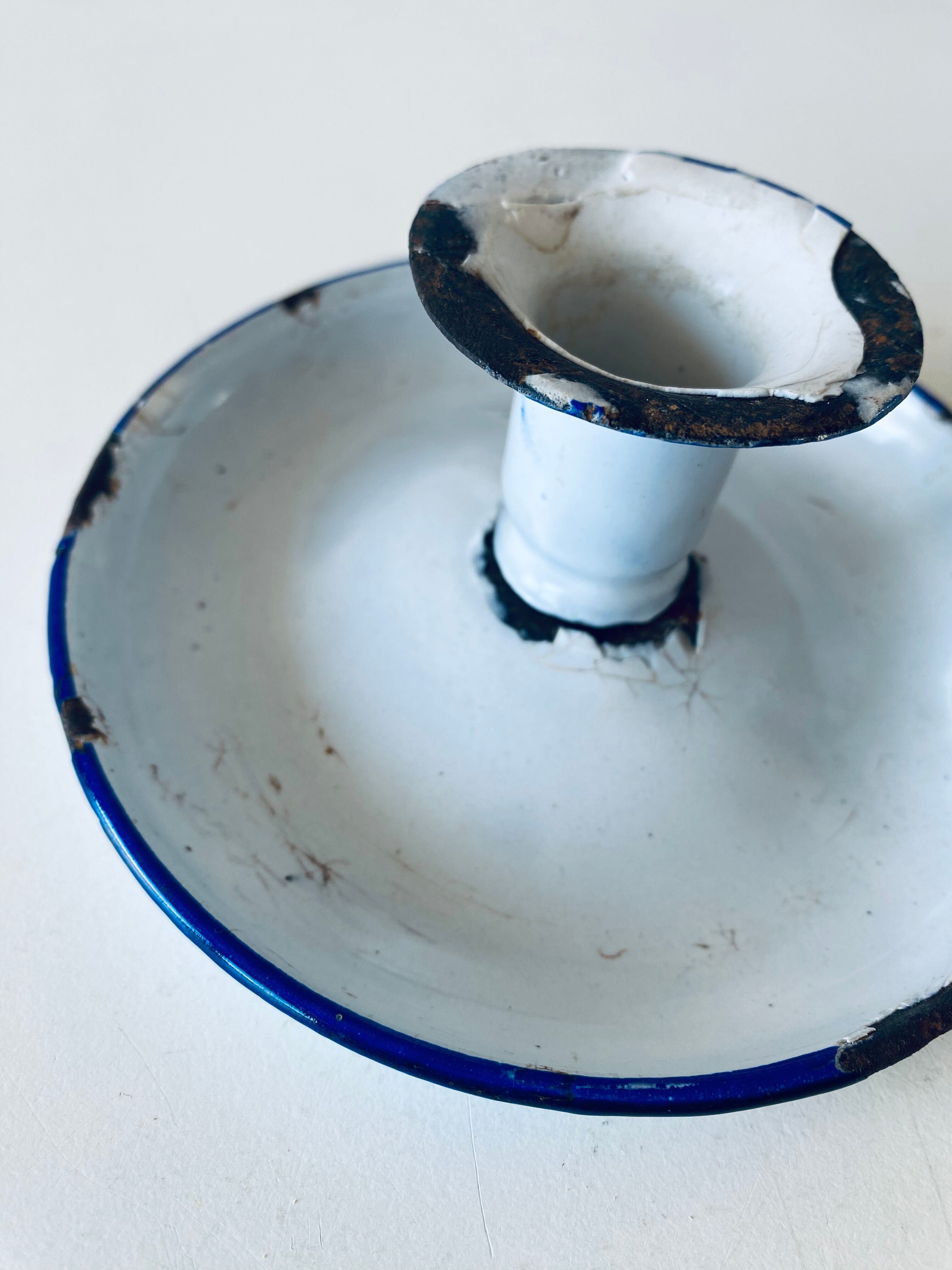 Antique candle holder in white and blue enamelled metal