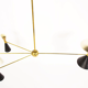 8-light brass chandelier and white-black and gold day blinds