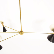 8-light brass chandelier and white-black and gold day blinds