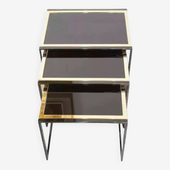 70s nesting side tables in black lacquered and gold-plated metal