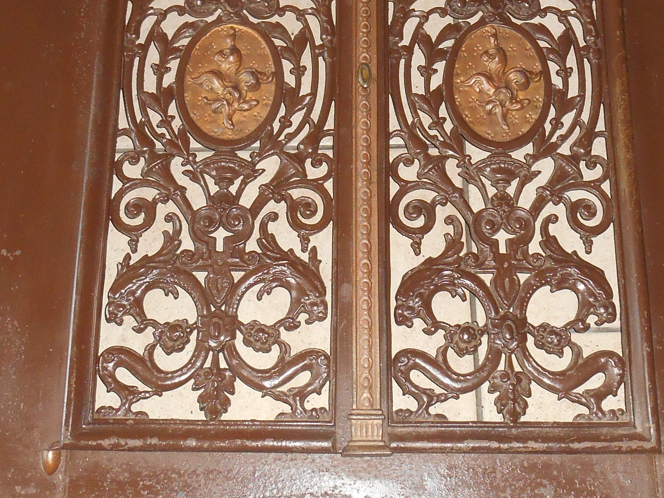 Pair of cast iron door grilles with its coat