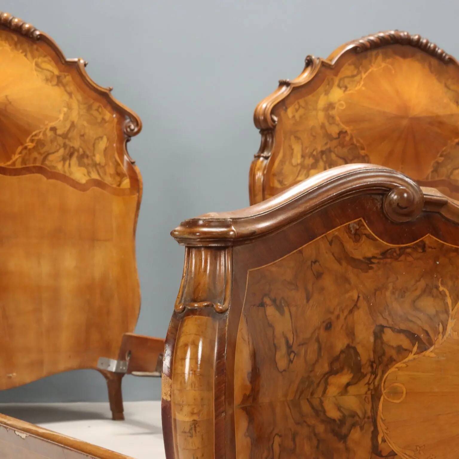 Simple old baroque-style beds in various woods from the 20th century.