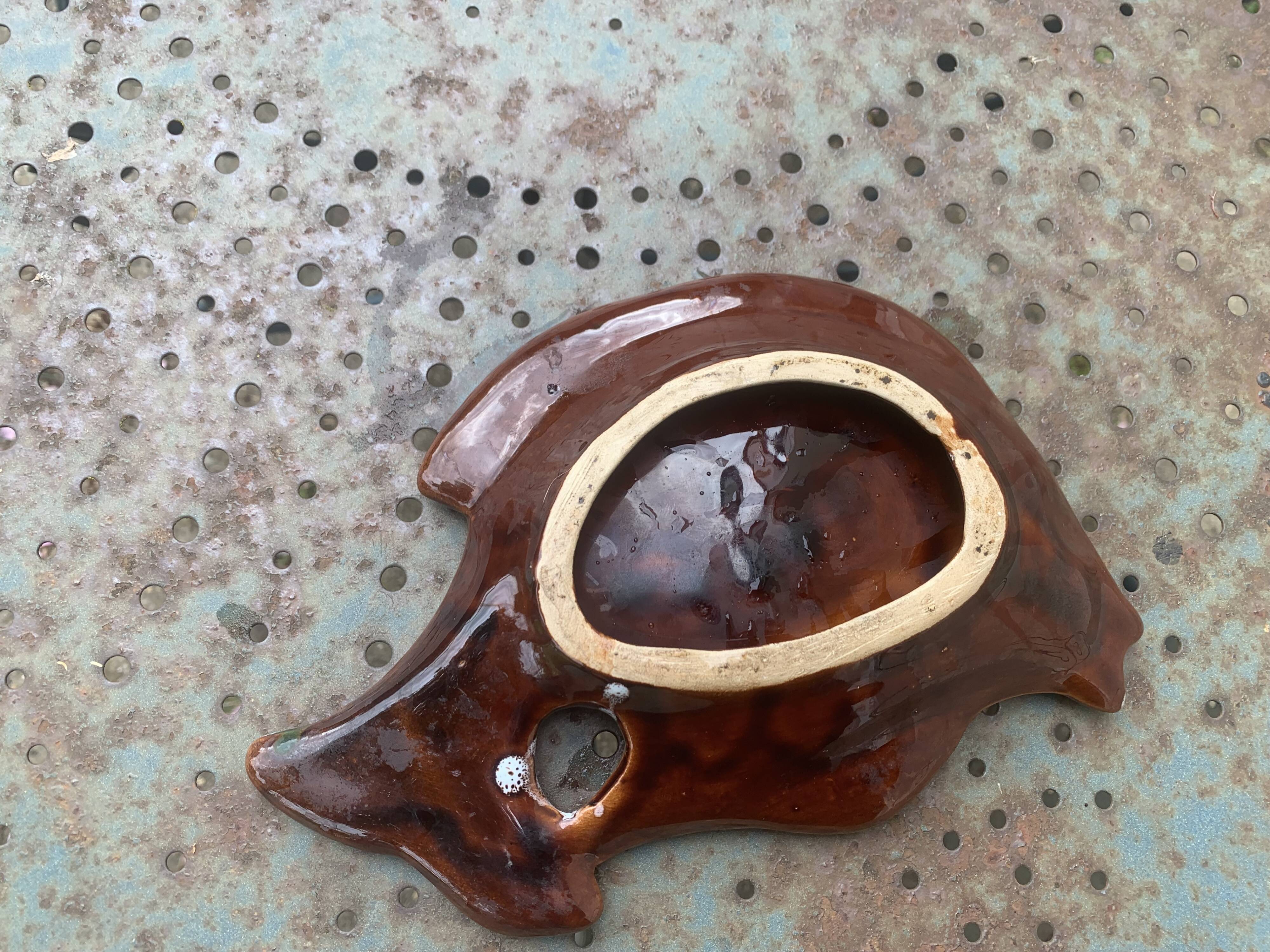 Empty pocket in glazed ceramic slip in the shape of vintage fish