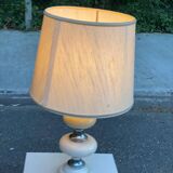Space age bedside lamp in off-white wood with a metal band.