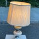 Space age bedside lamp in off-white wood with a metal band.