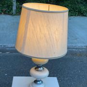 Space age bedside lamp in off-white wood with a metal band.
