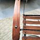 Folding garden chair with teak slats on a wrought iron structure