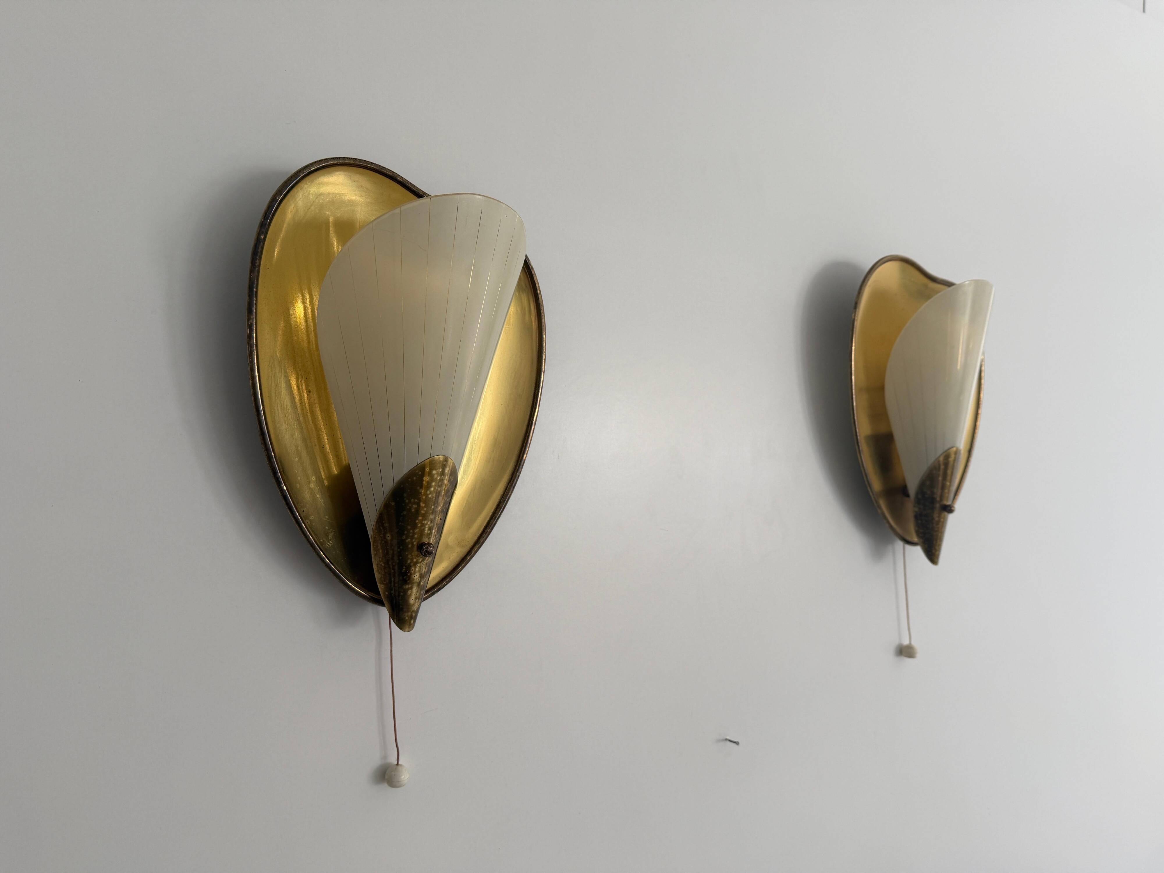 Pair of brass and glass wall lights from the mid-century, 1950s, Germany.