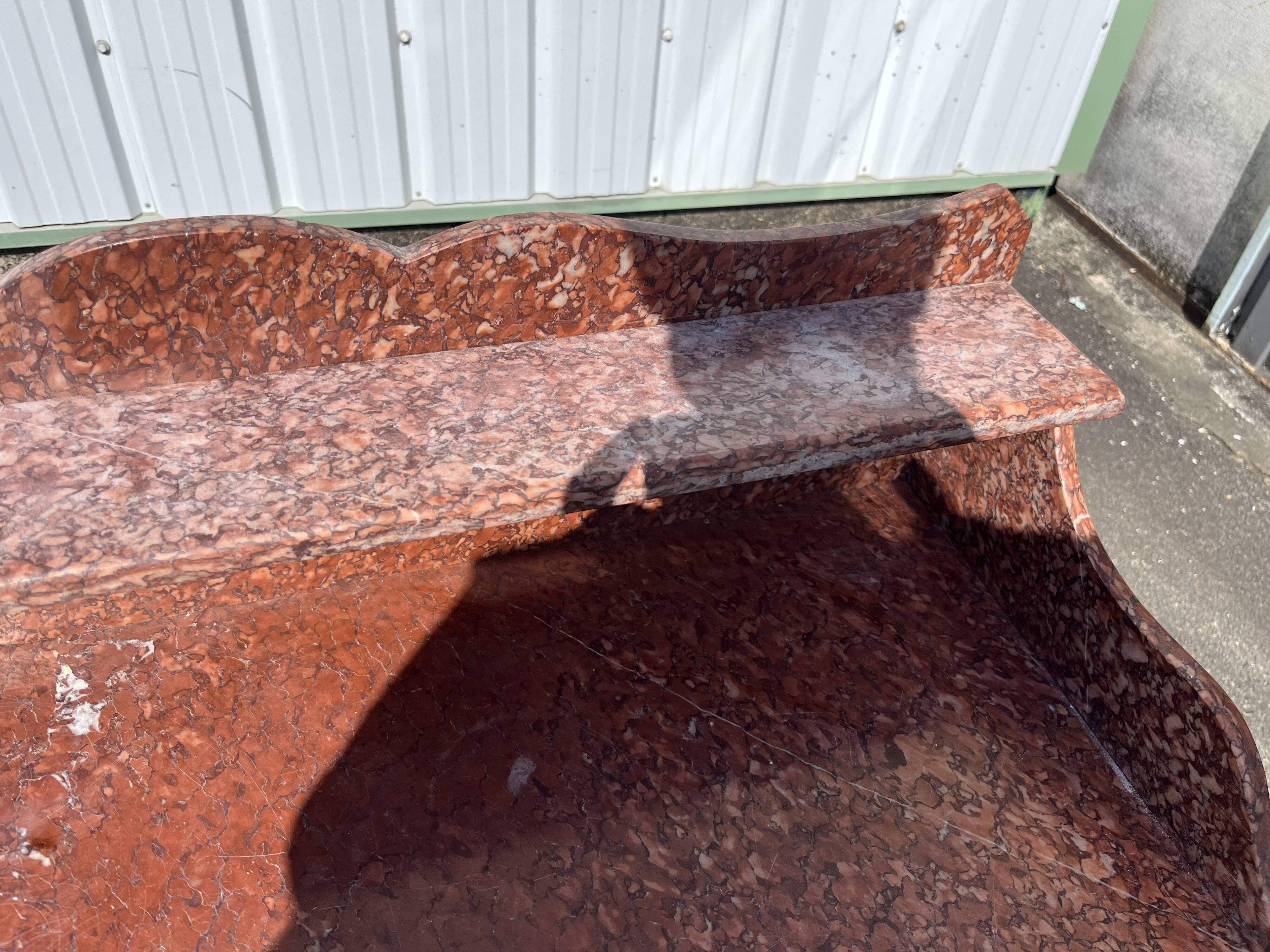 Antique wooden and red marble bathroom cabinet