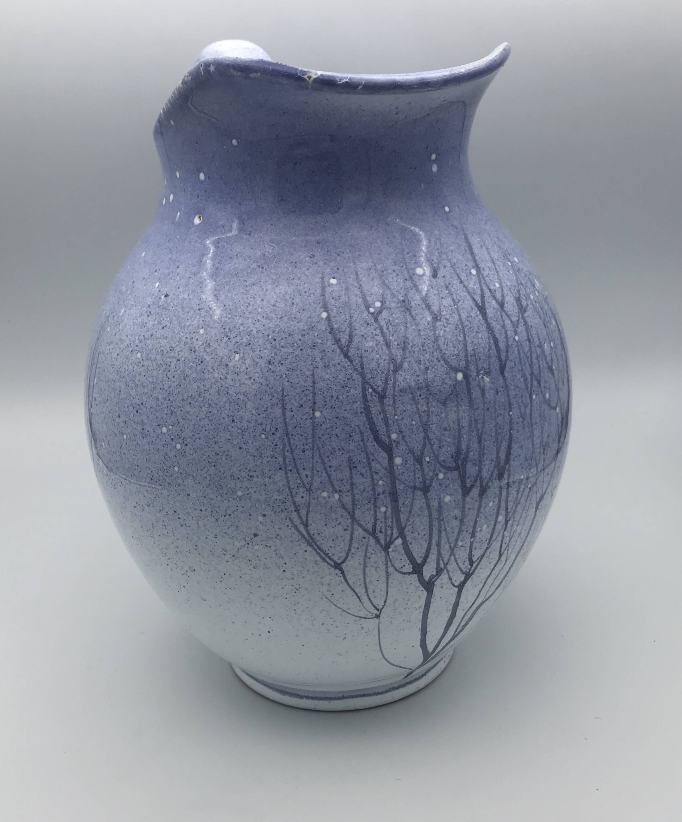 Blue glazed terracotta pitcher with hand-painted decoration, signed