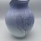 Blue glazed terracotta pitcher with hand-painted decoration, signed