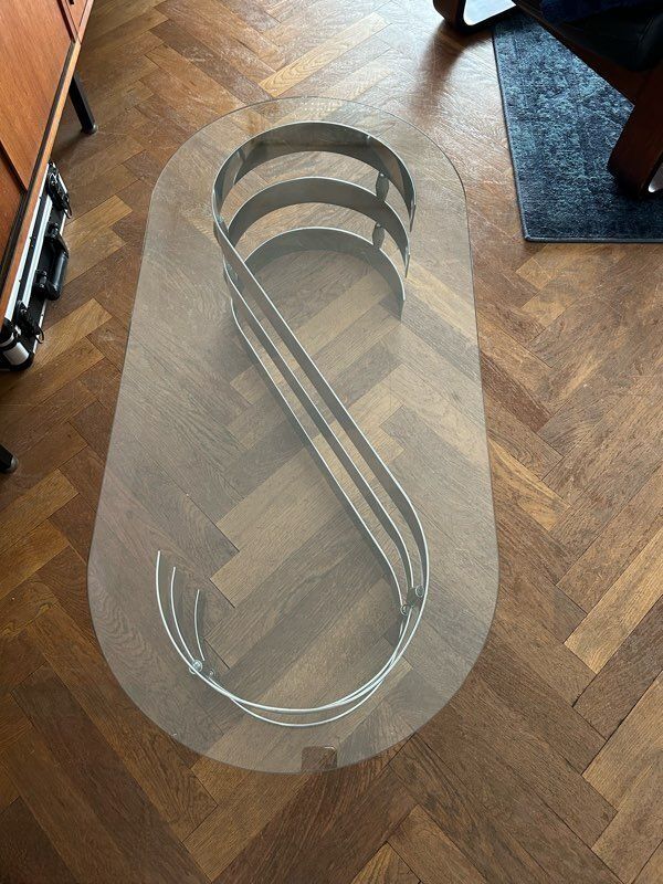 70s oval design coffee table in glass with chrome S legs.