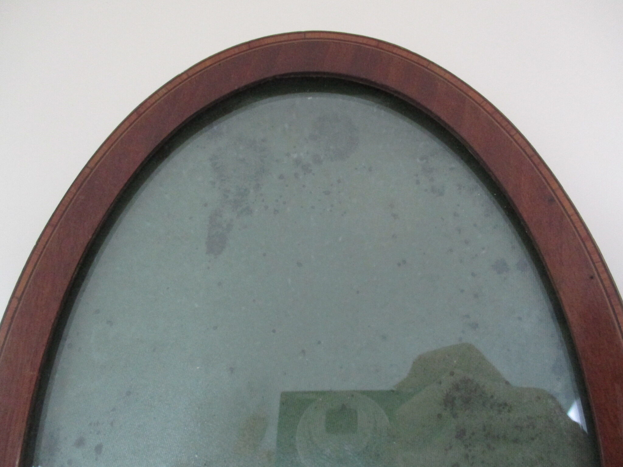 Oval wall frame in wood marquetry