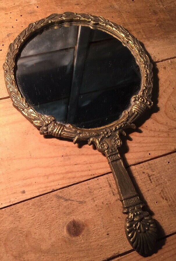 Antique mirror facing round hand in bronze 23cm