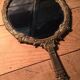 Antique mirror facing round hand in bronze 23cm