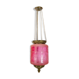 Antique pendant of pink opaline glass with brass edge and suspension from around 1860