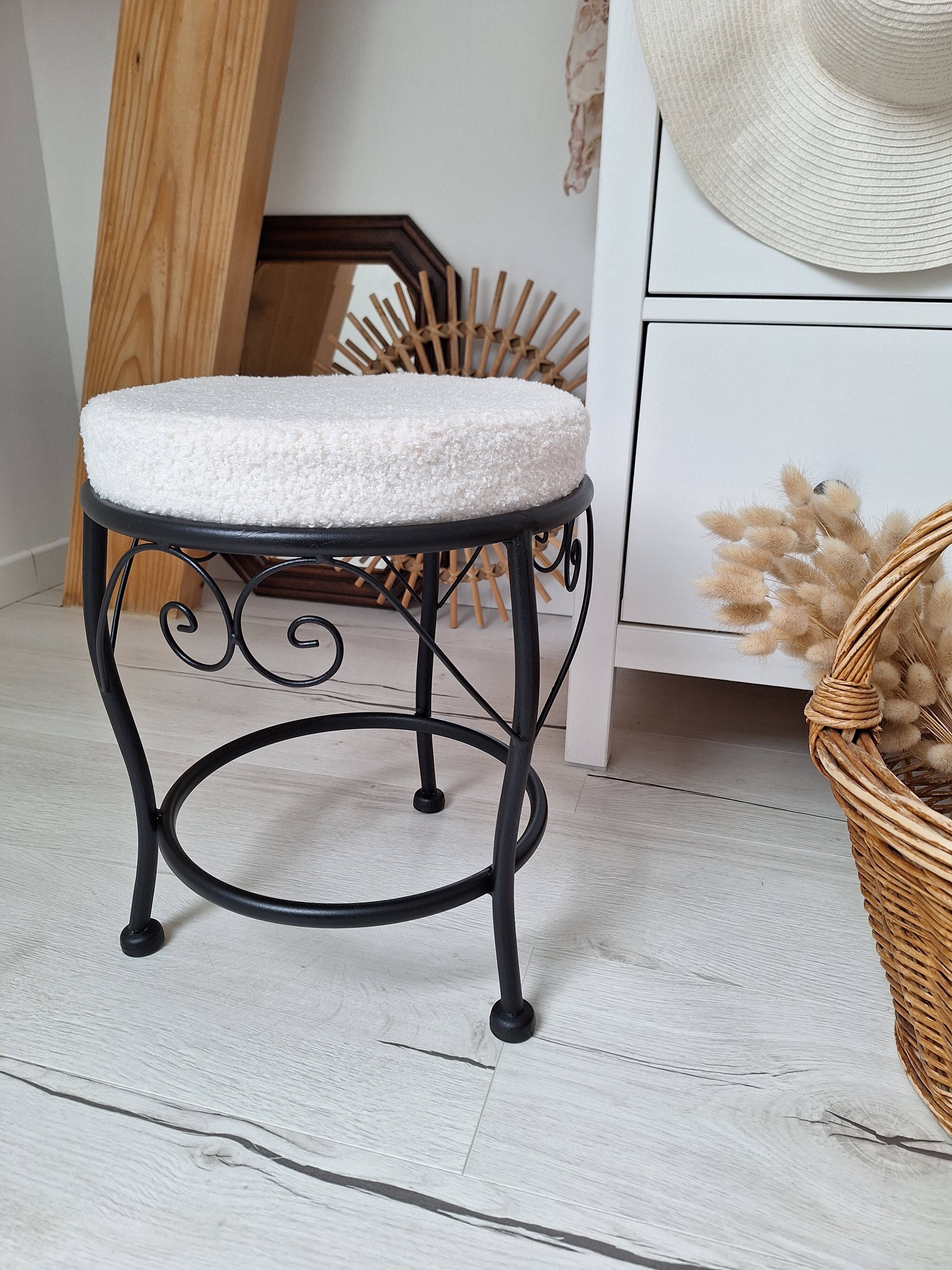 Black iron stool/pouf with its boucle fabric cushion.